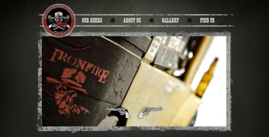 Screenshot of the Ironfire Brewing Company website homepage, with its western-themed skull-and-pistols logo, navigation menu, and a close-up photo of a beer crate.